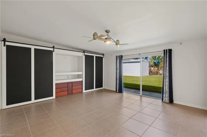Family room with built in entertainment center with sliding barn doors