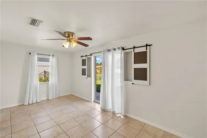 Primary room featuring ceiling fan and plenty of natural light