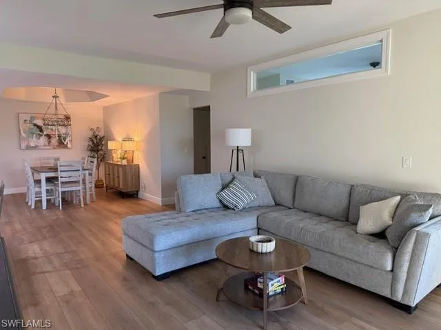 Living area featuring wood finished floors and ceiling fan