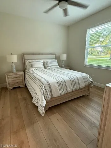 Bedroom with wood-type flooring and a ceiling fan
