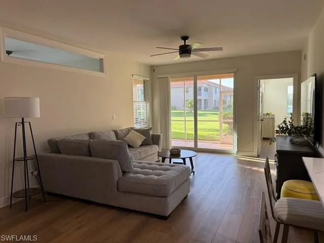 Living room with wood finished floors and ceiling fan