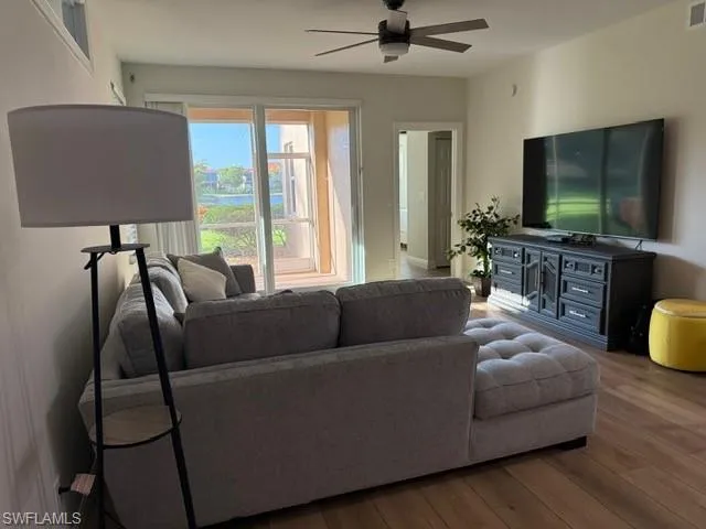 Living room with wood finished floors and ceiling fan
