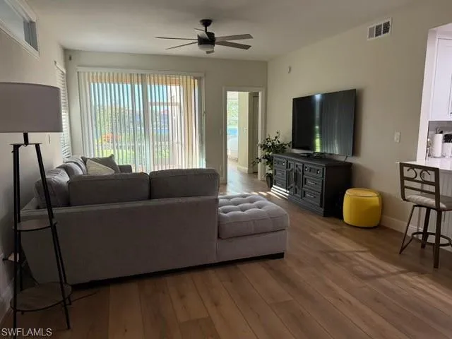 Living area with wood finished floors and a ceiling fan
