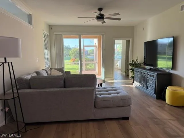 Living area featuring wood finished floors and a ceiling fan