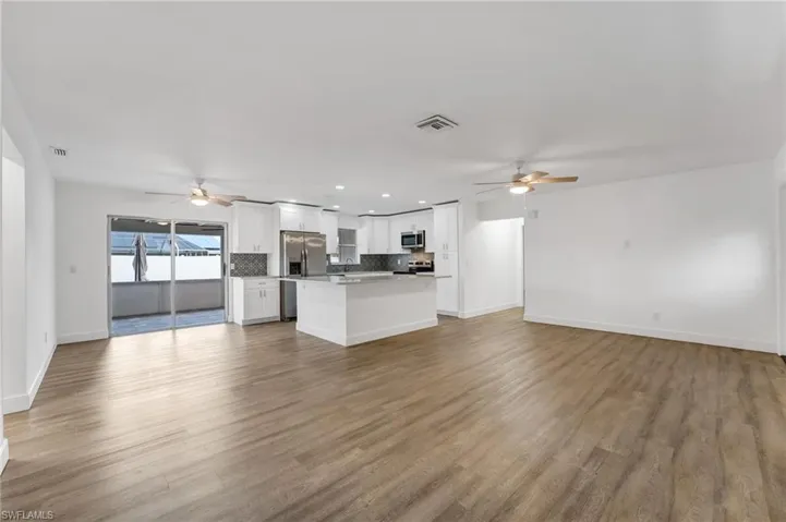 Beautifully remodeled open-concept kitchen designed for effortless entertaining, filled with natural light and a bright, airy ambiance.