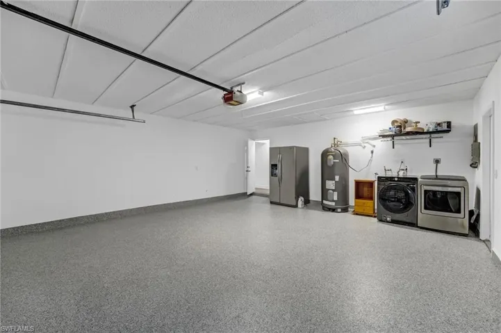 Oversized deep 2 car garage has a finished epoxy floor.