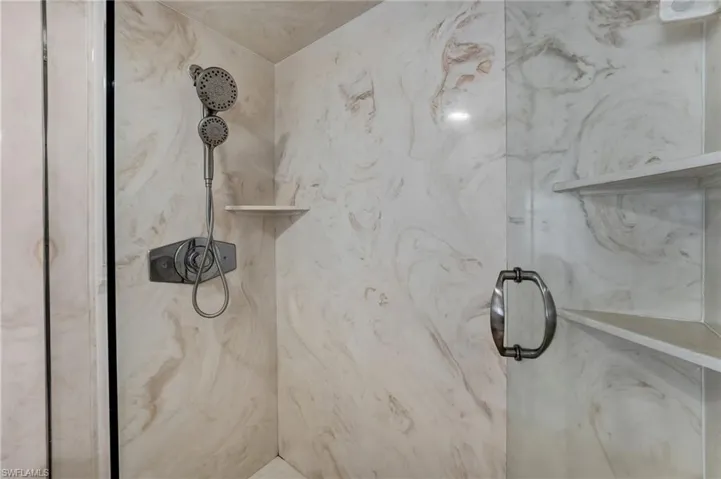 Primary bath has a wak in shower with seamless glass enclosure.