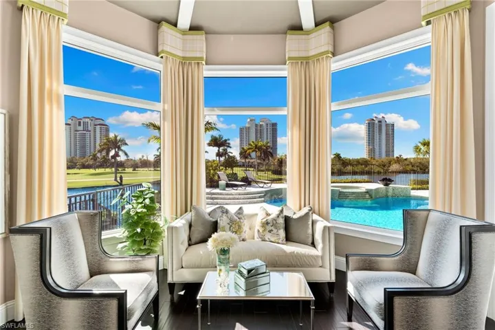 Primary bedroom sunroom featuring a water view and a jacuzzi