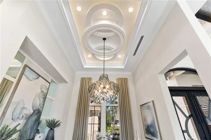 Detailed view of custom ceiling, hanging lights, and ornamental molding