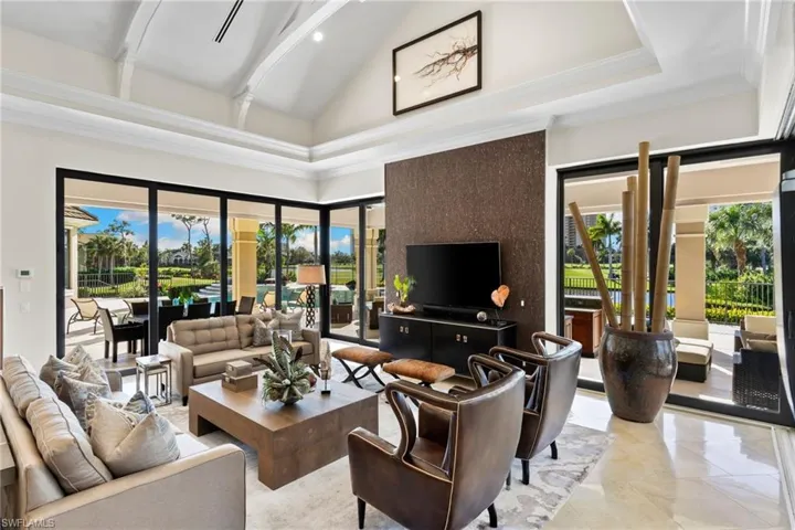 Living room featuring vaulted ceiling and recessed lighting