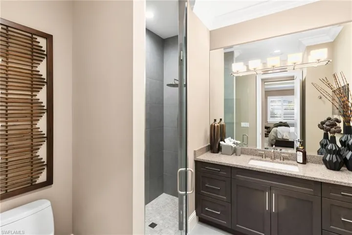 Full bath with vanity, a stall shower, recessed lighting, ensuite bath, and ornamental molding