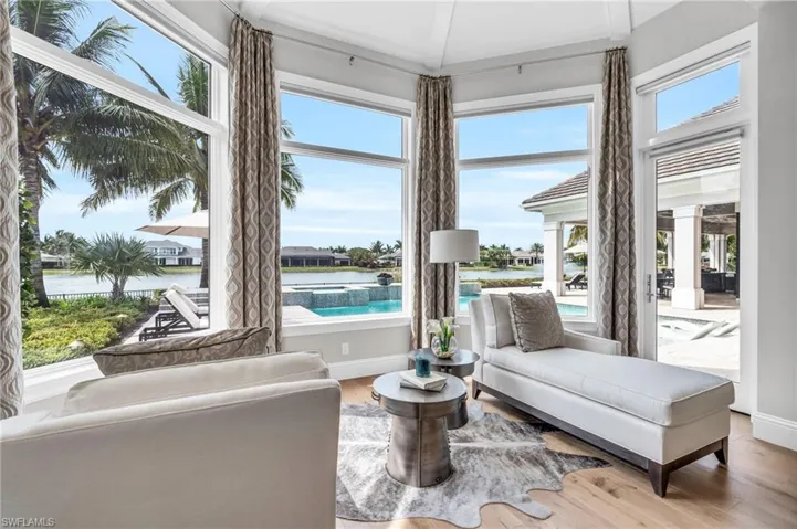 Master suite complete with a sitting area overlooking the pool