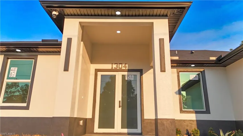 Entrance to property featuring french doors and stucco siding
