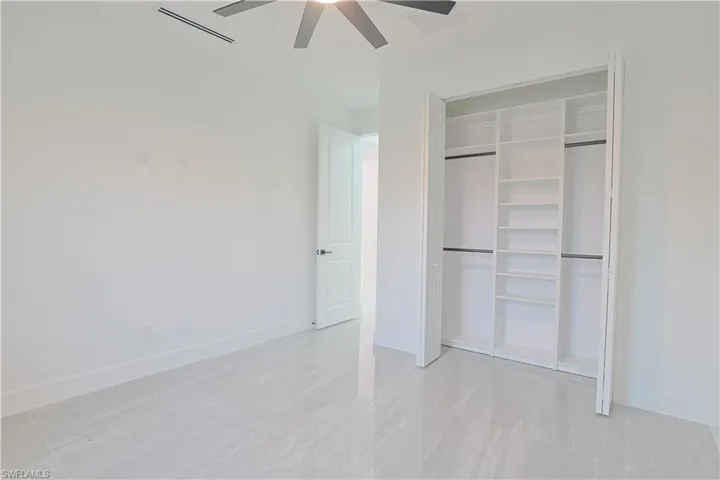 Unfurnished bedroom featuring a closet and a ceiling fan