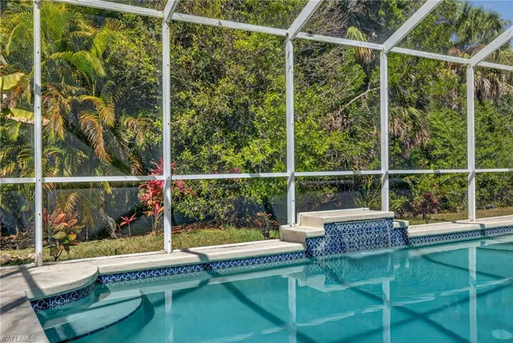 Swimming pool with a lanai and a sunroom