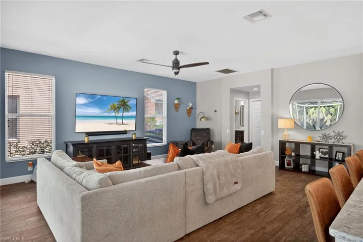 Living room featuring dark wood finished floors and a ceiling fan
