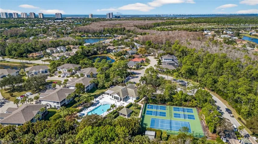 Aerial view of residential area featuring a nearby body of water