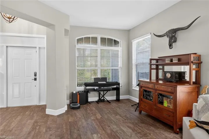 Office featuring dark wood finished floors and baseboards