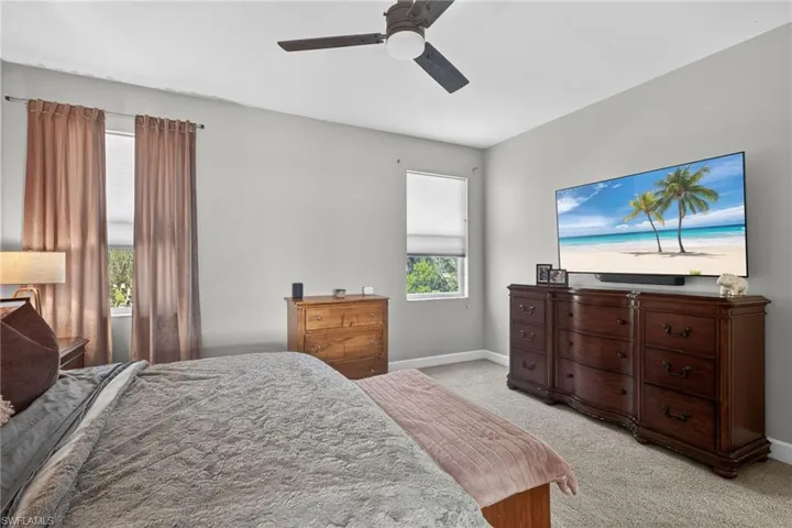 Bedroom featuring light colored carpet and a ceiling fan