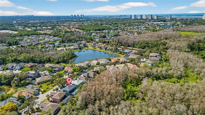 Aerial view of residential area featuring a nearby body of water