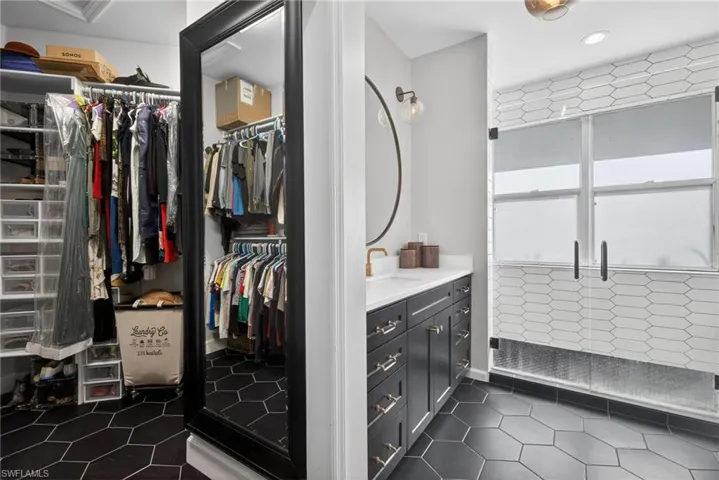 Walk in closet featuring dark tile patterned flooring