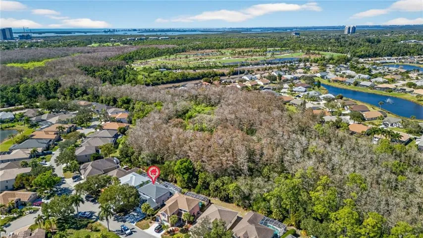 Aerial perspective of suburban area with a nearby body of water