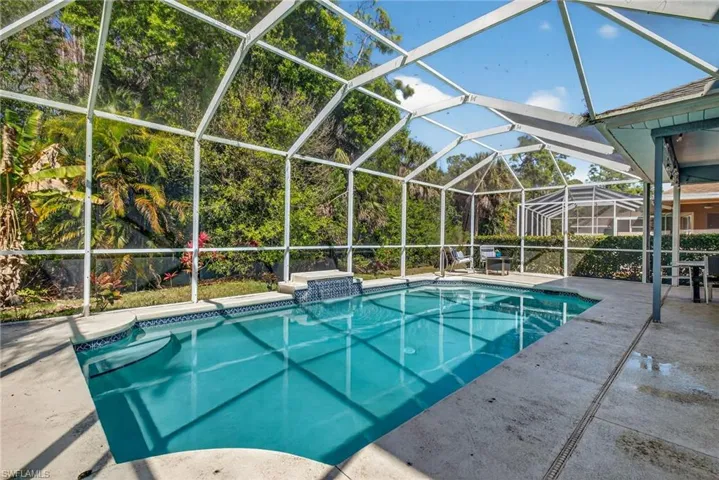 Outdoor pool featuring a lanai, a patio area, and a sunroom