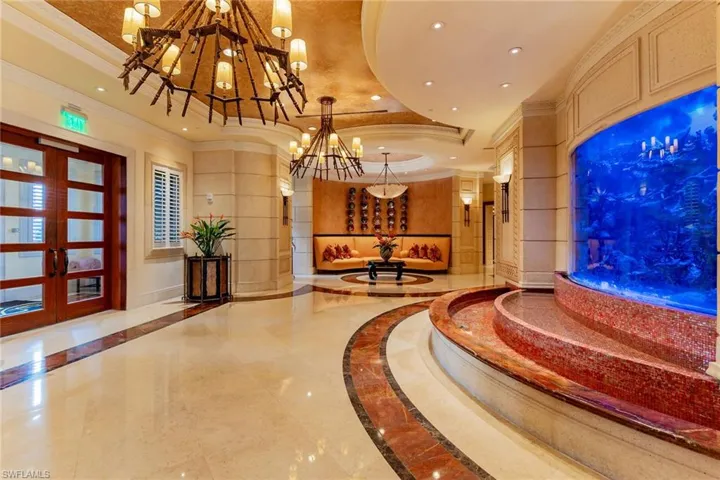 Common area featuring a raised ceiling, crown molding, and recessed lighting