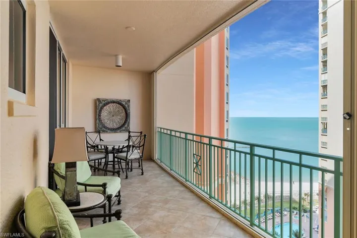 Balcony with view of water and beach
