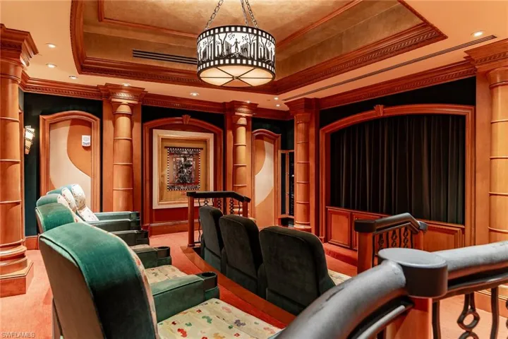 Cinema room featuring ornamental molding, recessed lighting, a tray ceiling, and light colored carpet