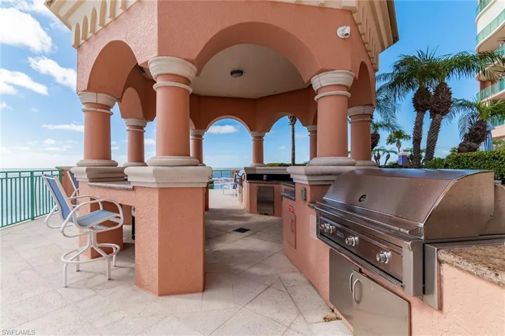 View of patio featuring area for grilling and a water view