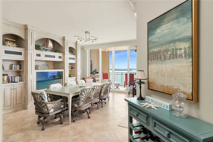 Dining space with built in features, light tile patterned flooring, and floor to ceiling windows