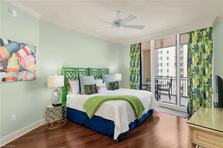 Bedroom featuring crown molding, wood finished floors, access to outside, ceiling fan, and floor to ceiling windows