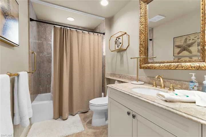 Full bath featuring vanity, shower / bath combination with curtain, recessed lighting, and light tile patterned floors