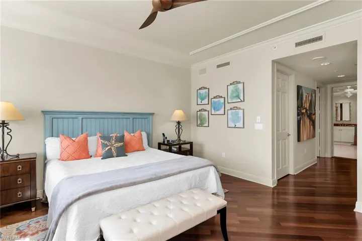 Bedroom featuring dark wood-style flooring, a ceiling fan, and crown molding