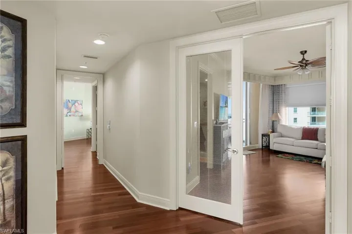 Corridor featuring dark wood-style flooring and recessed lighting