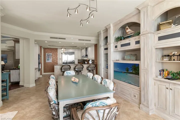 Dining room featuring ornamental molding and light tile patterned floors