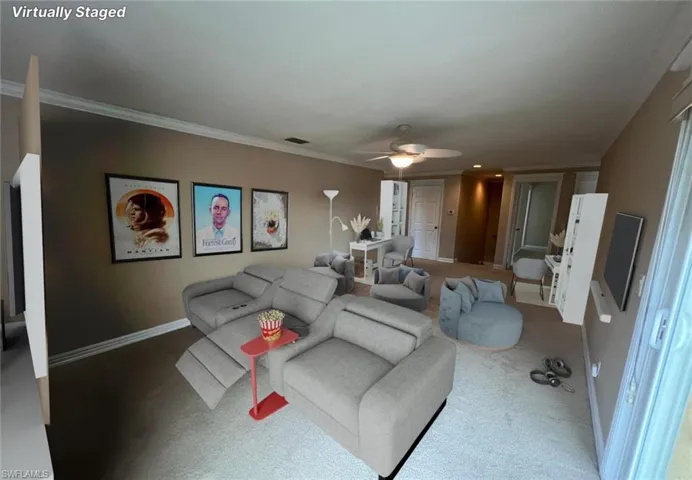 Carpeted living room with ornamental molding and ceiling fan