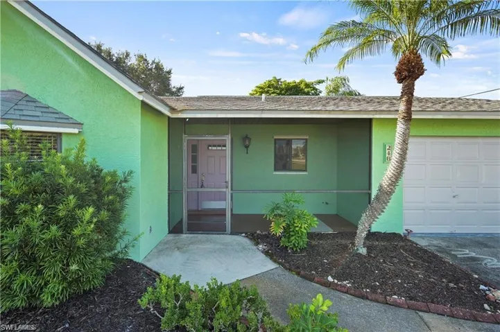 View of exterior entry featuring a garage