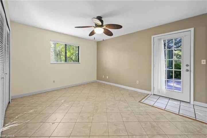 Tiled empty room featuring ceiling fan
