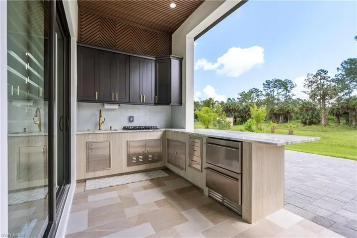 Kitchen featuring a sink, a peninsula, and decorative backsplash