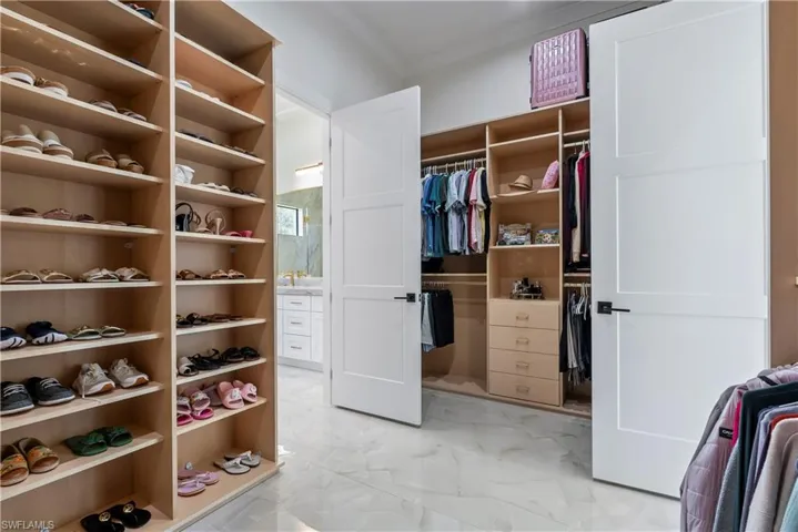 Walk in closet with marble finish floor