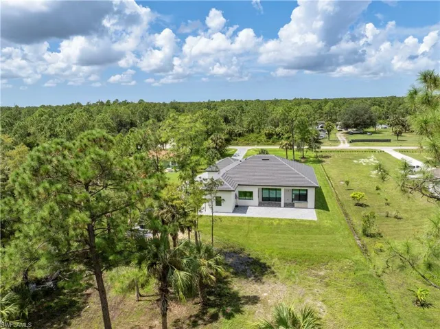 Drone / aerial view with a wooded view
