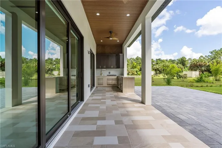 View of patio with ceiling fan and an outdoor kitchen