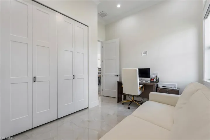 Office featuring marble finish floor, visible vents, and recessed lighting