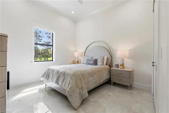 Bedroom featuring baseboards, marble finish floor, ornamental molding, and recessed lighting