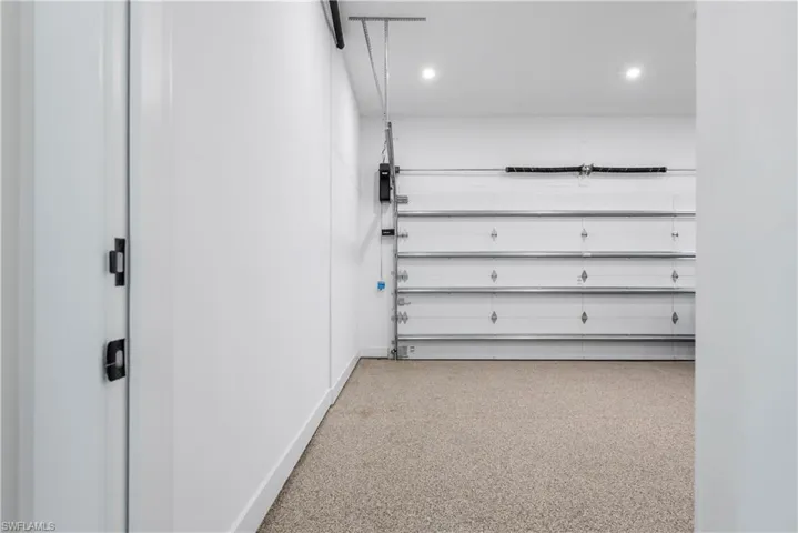 Garage with baseboards and recessed lighting