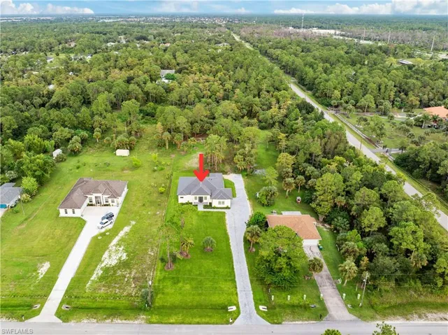 Drone / aerial view featuring a wooded view