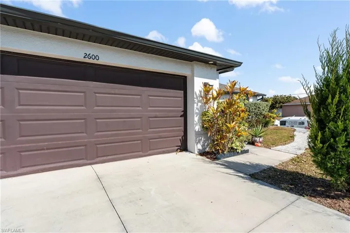 Garage featuring concrete driveway