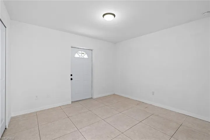 Entrance foyer featuring baseboards and light tile patterned floors